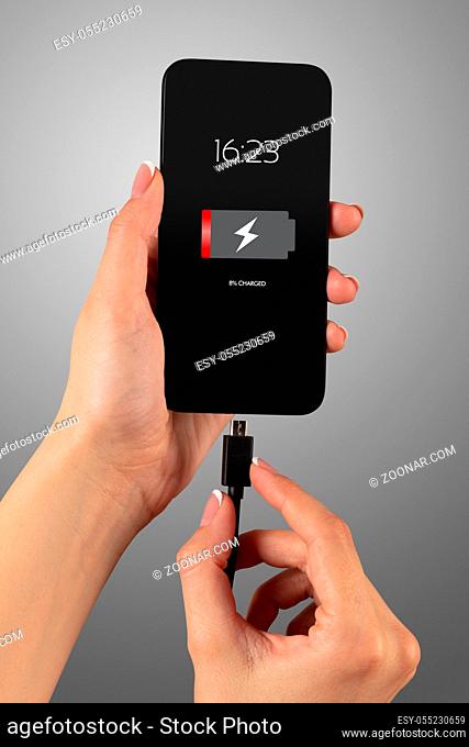 Elegant hand charging smartphone with low battery