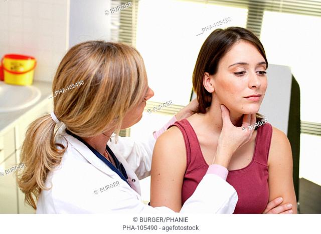 Doctor examining the thyroid gland of a patient