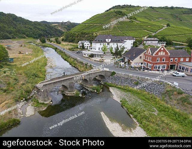 PRODUCTION - 28 June 2023, Rhineland-Palatinate, Rech: The historic arched bridge over the Ahr River in Rech, which was destroyed during the flood (aerial...