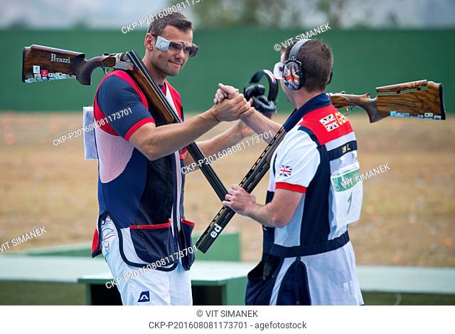 Fourth David Kostelecky (left) of Czech Republic congratulates to Edward Ling of Great Britain after the men's trap final at the 2016 Summer Olympics in Rio de...