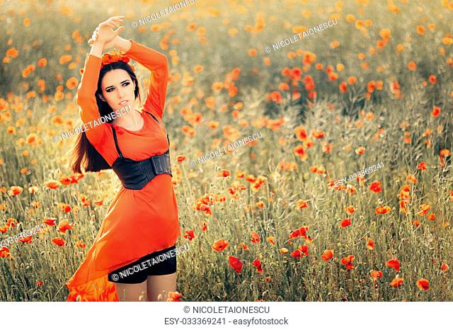 Portrait of a happy girl in red chiffon blouse and black corset in summer floral landscape