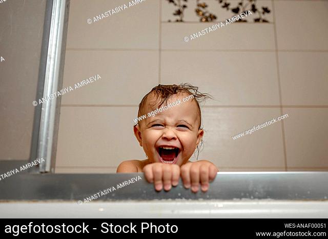 Baby boy shouting in bathtub