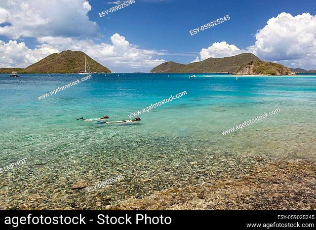 Snorkelers in Leinster Bay with boats in harbor on the island of St. John in the United States Virgin Islands