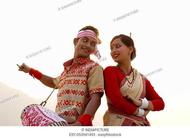 Bihu dancers standing back to back