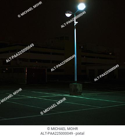 Street light in parking lot, night