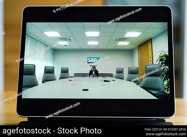 27 January 2022, Baden-Wuerttemberg, Walldorf: Oliver Roll, press spokesman for the software company SAP, sits at a table with unoccupied chairs during an...