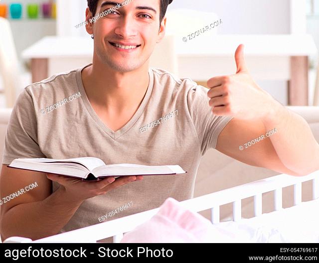 The young dad student preparing for exams and looking after baby