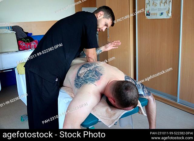 PRODUCTION - 06 October 2023, Ukraine, Kiew: A wounded Ukrainian soldier in a surgical hospital receives a massage as part of his rehab