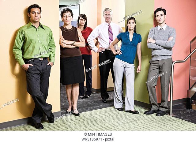 Mixed race team of workers in an office hallway