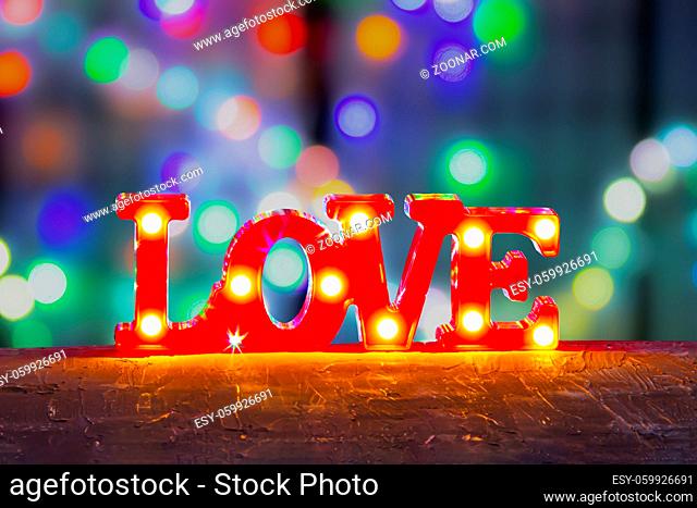 LOVE sign Bedroom Decor with Lights LED Marquee Letters on red with colourful defocused lights background