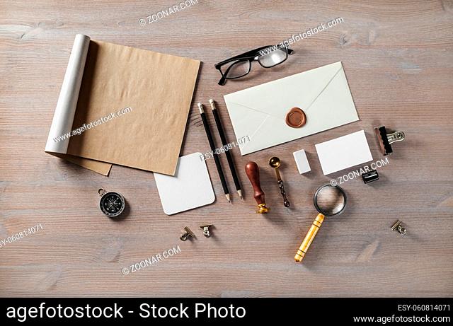Blank envelope and vintage stationery on wood table background. Flat lay