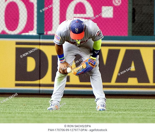 New York Mets left fielder Yoenis Cespedes (52) looks down after trapping the ball that resulted in the Washington Nationals scoring the winning run in the...