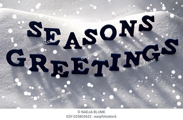 Blue Letters Building English Text Seasons Greetings On White Snow. Snowy Landscape Or Scenery With Snowflakes. Christmas Card For Seasons Greetings Or Usable...