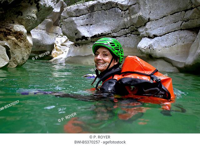 Canyoning in the Jabron river, woman swimming in the river, France, Provence, Trigance