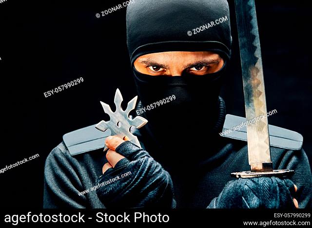 Ninja samurai warrior fighter with a sword and shuriken over black background. japanese fighter concept