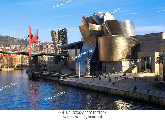 Guggenheim Museum and the scuplture “Tall tree and the eye” by Anish Kapoor with “La Salve” bridge on the bagkground, Bilbao, Vizcaya, Basque Country, Spain