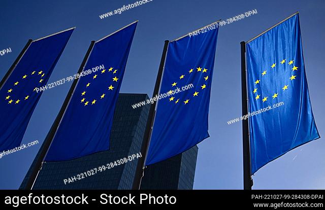 27 October 2022, Hesse, Frankfurt/Main: EU flags hang from poles in front of the European Central Bank (ECB) headquarters. Photo: Arne Dedert/dpa