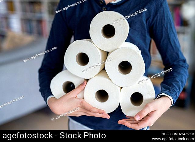 Person holding toiler paper rolls
