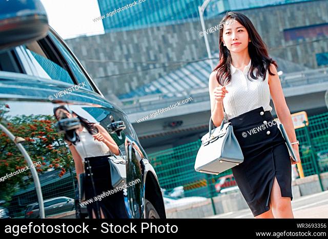 Car at the side of beautiful business women