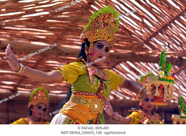 Balinese women dancing Tari Pendet Dance. Pendet is a traditional dance from Bali, Indonesia, in which floral offerings are made to purify the temple as a...