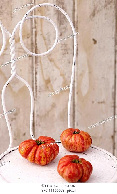 Three Heirloom Tomatoes on a White Chair
