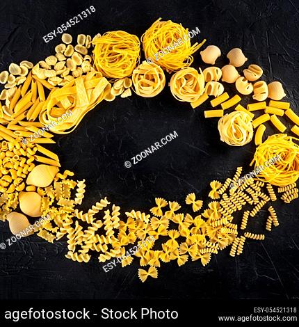 Italian pasta sqaure design with copyspace, a flat lay of a variety of pasta types, shot from above on a black background