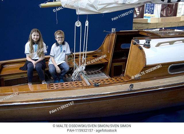 The boat models Noah and Natessa on a historic wooden sailboat in the Classic Forum, at the boat 2019, boat show 2019 in Duesseldorf from 19 to 27 January 2019