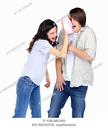 Happy young girl smashing cake on a boy's face over white background