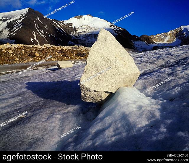 Glacial erratic balanced on ice of glacier feeding Boulder Creek, Little Cathedral Mountains of the Alaska Range, Alaska