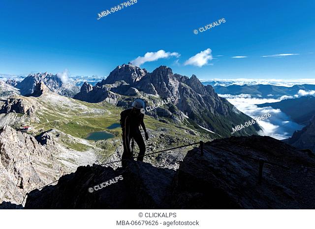 Sesto/Sexten, Dolomites, South Tyrol, province of Bolzano, Italy. Climber on the via ferrata De Luca-Innerkofler to the summit of Monte Paterno