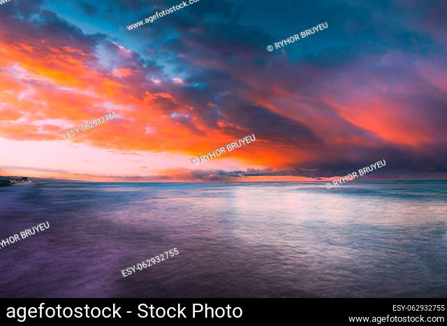 Summer Colorful Sky At Sunset Or Sunrise Over Sea Ocean. Amazing Orange Blue Bright Dusk Sky Above Sea. Calmness And Tranquility