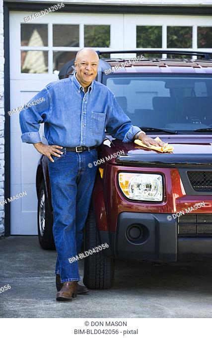 Senior African American man polishing car