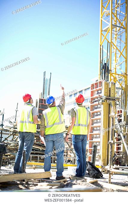 Three construction workers in construction site