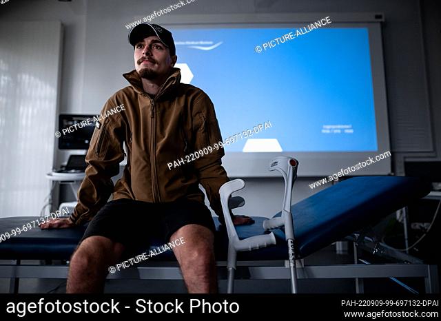09 September 2022, North Rhine-Westphalia, Bochum: Professional soldier Aleksandr, called Sasha, sits on a couch in the hospital