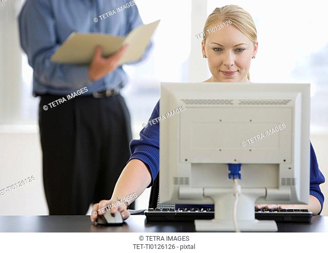 Businesswoman using computer at desk