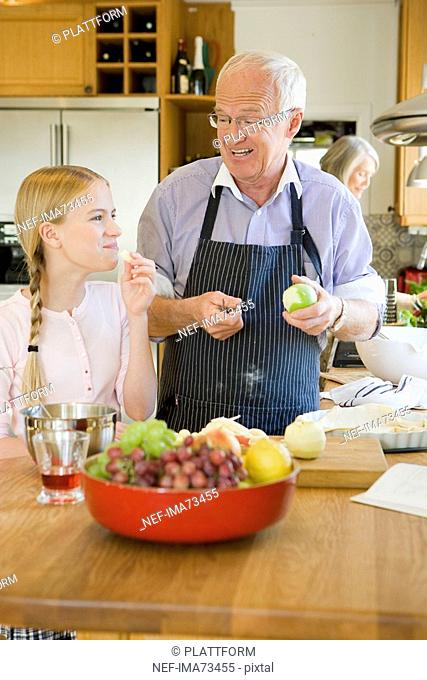 Senior couple baking with their granddaughter, Sweden