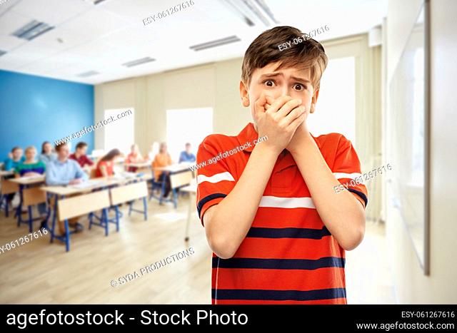 scared student boy clothing mouth at school