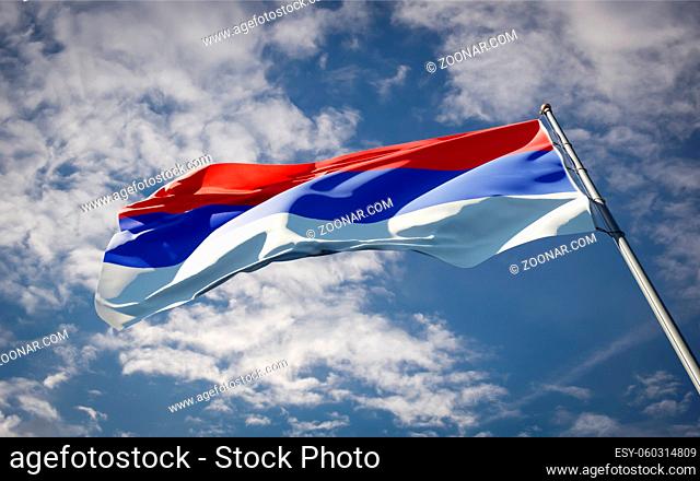 Beautiful national state flag of Srpska fluttering at sky background. Low angle close-up Srpska flag 3D artwork