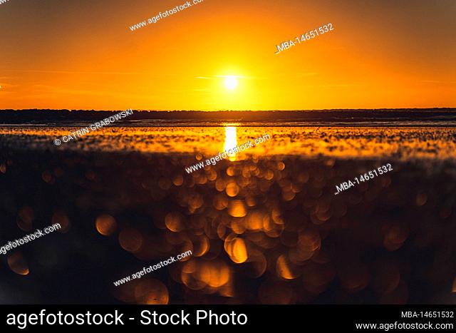 Sunset on Norderney, blurred foreground with reflections