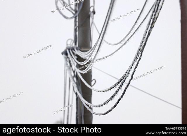 RUSSIA, ROSTOV REGION - DECEMBER 15, 2023: Ice-covered wires of a power transmission line are pictured after freezing rain in the village of Krasny Krym