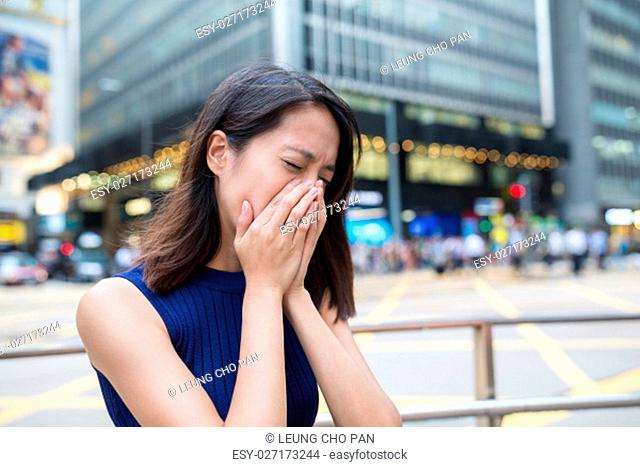 Woman sneeze at outdoor