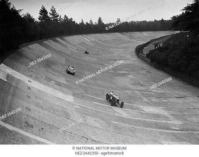 Frazer-Nash and Frazer-Nash BMW racing on the banking at Brooklands, 1938 or 1939. Artist: Bill Brunell