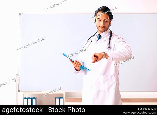 Young doctor in front of whiteboard