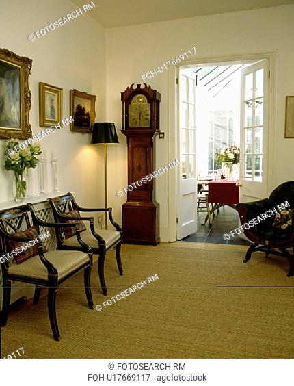 Longcase clock and cream carpet in traditional white hall