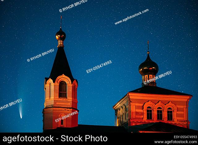 Korma Village, Dobrush District, Belarus. Comet Neowise C2020f3 In Night Starry Sky And St. John The Korma Convent Church In Korma Village