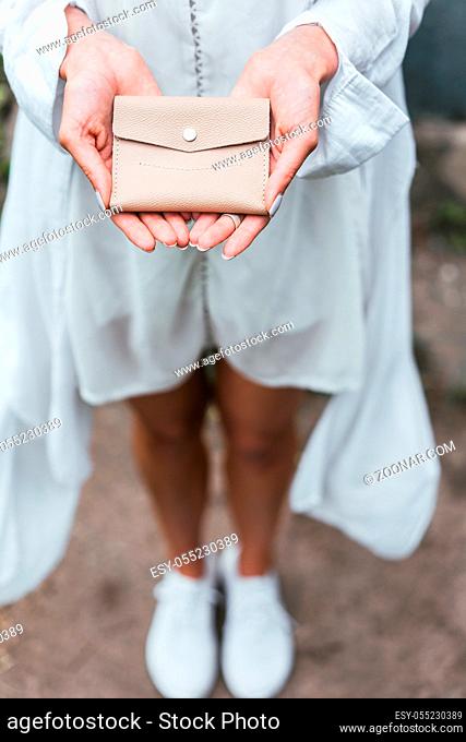 Beautiful woman hands with sweet cute manicure hold purse