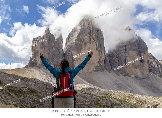 Girl looking at the impressive three peaks of Lavaredo, on a circular route walking around the top peaks