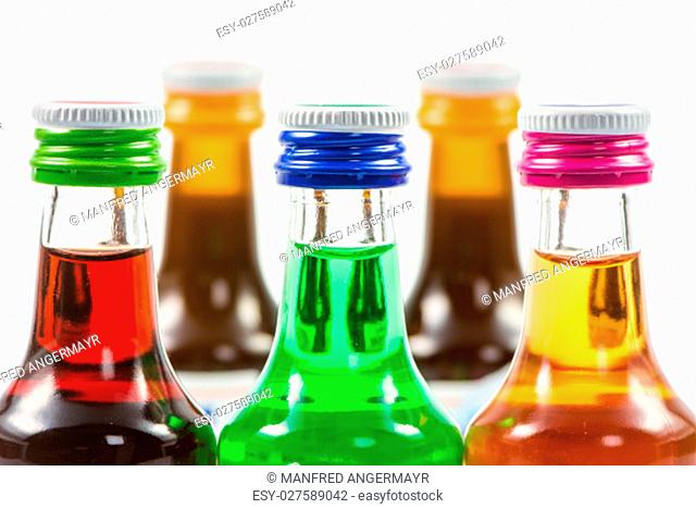 Closeup of various isolated liqueur bottles with party drinks