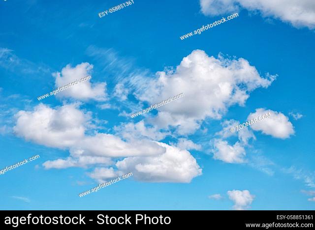 The bright blue cloudy sky in the summer midday