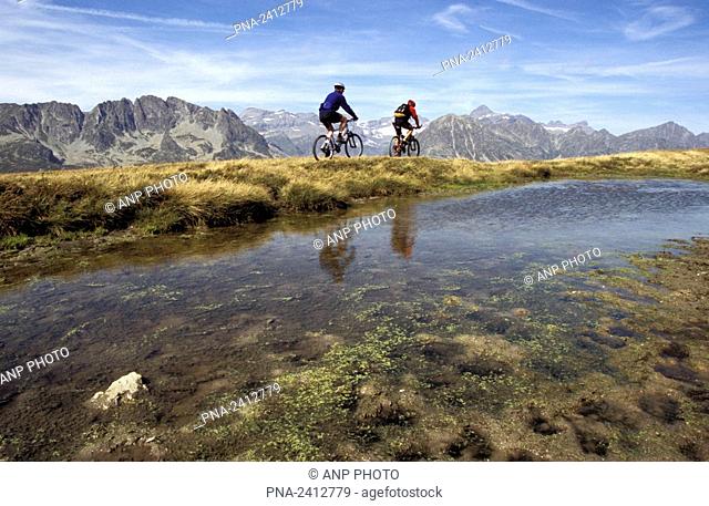 Mountain bikers on the boarder between France and Switzerland. Walliser Alpen